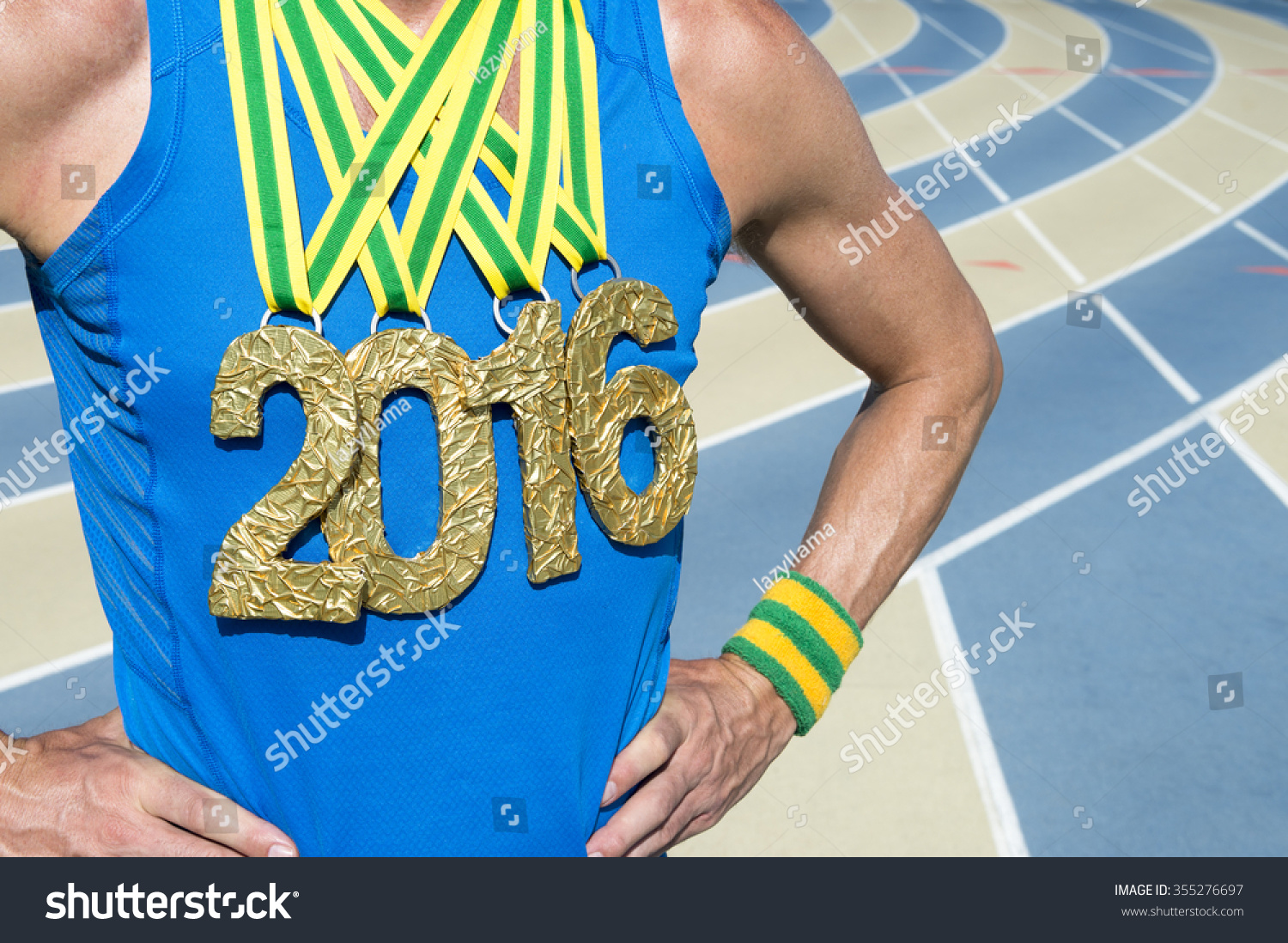 gold medal 2016 athlete standing at blue and tan outdoor running